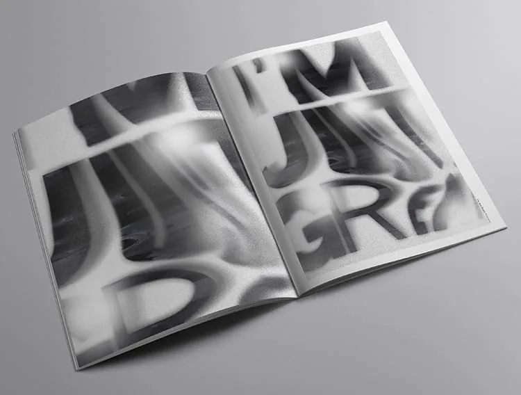 An open spread of large blurred black type on white