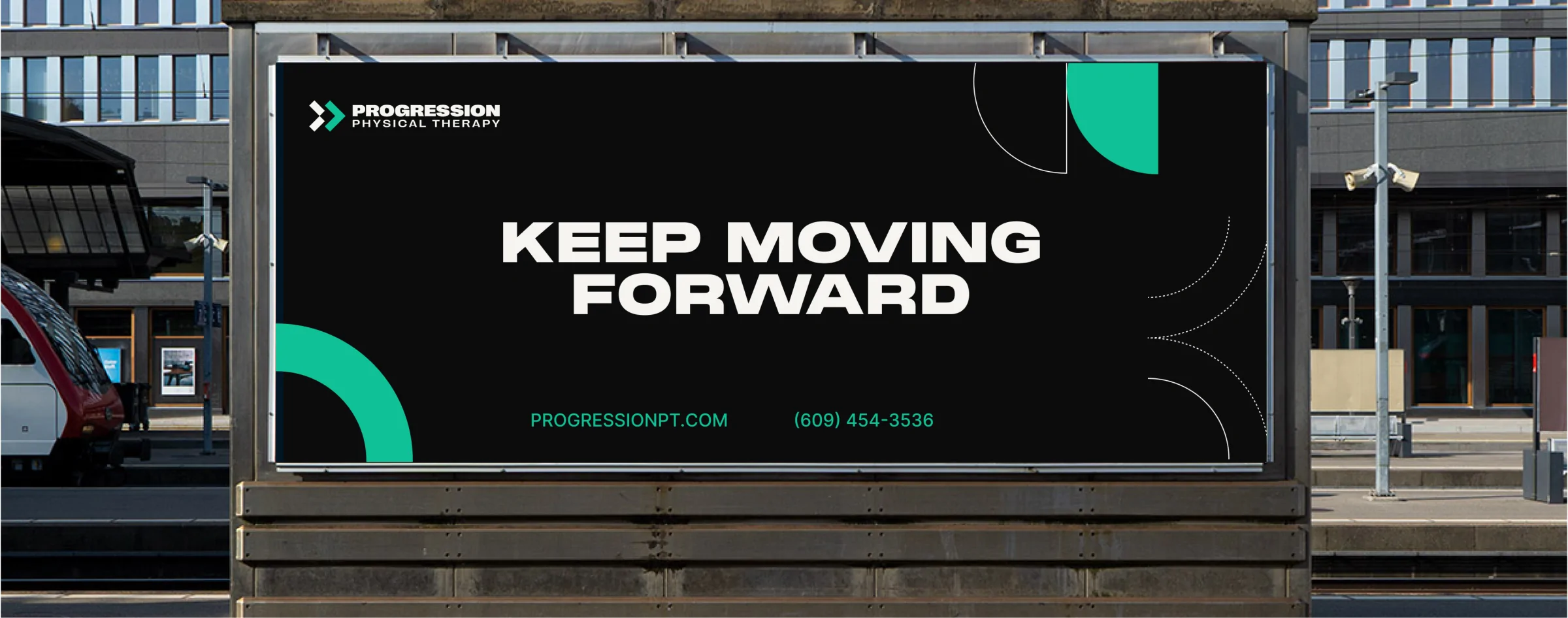 A Progression billboard reading Keep moving forward at a train station